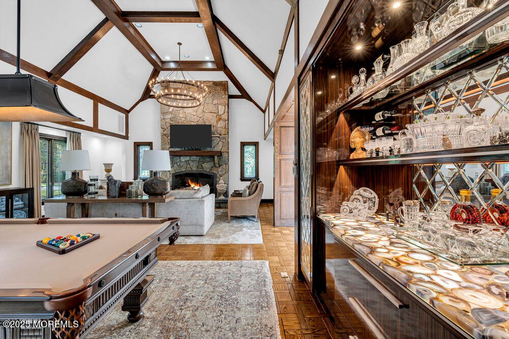 Billiard Table, Chandelier, Fireplace, Game Room, Interior, Recessed Lighting, Stone Walls, Wood Texture Flooring