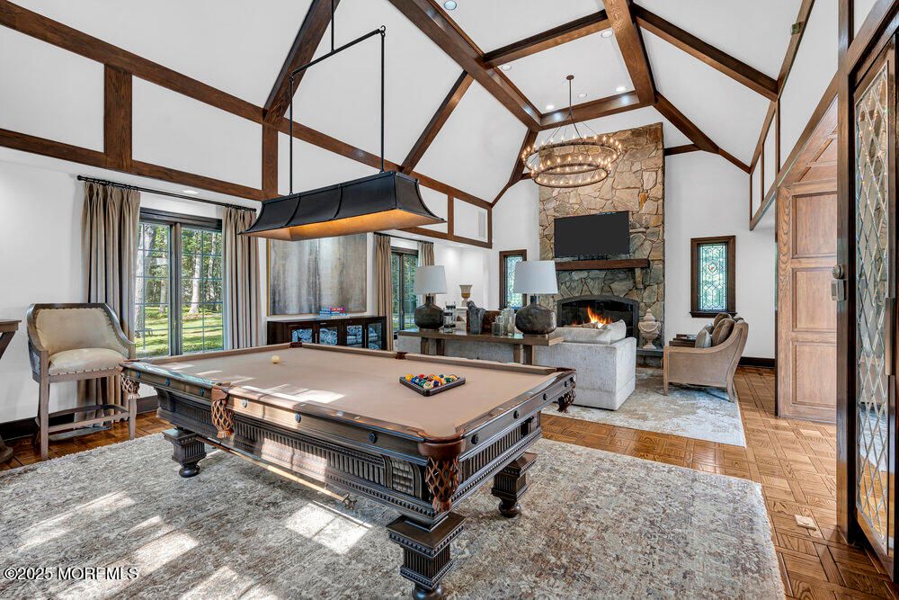 Billiard Table, Chandelier, Fireplace, Game Room, Interior, Living room, Pendant Lights, Stone Walls, Wooden Beams, Wood Texture Flooring