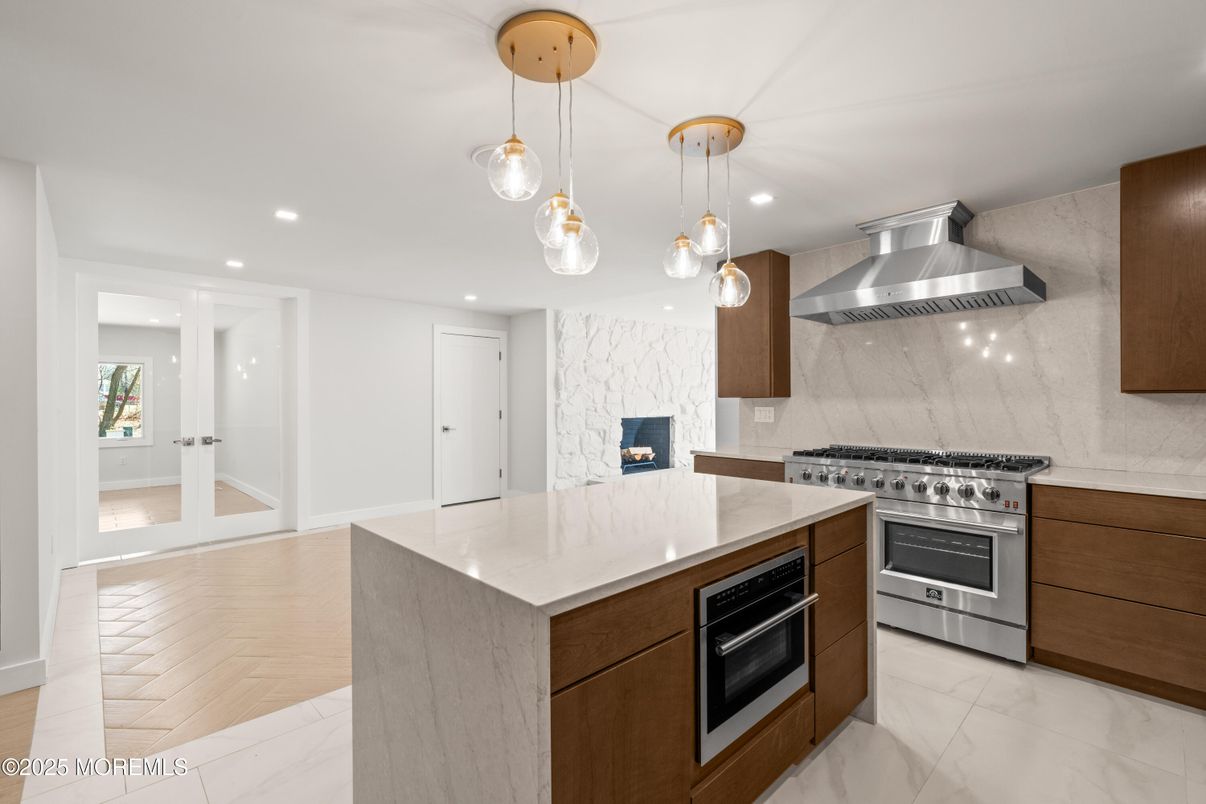 Interior, Kitchen, Marble, Marble Walls, Pendant Lights, Recessed Lighting, Stainless Steel Appliances, Wood Texture Flooring