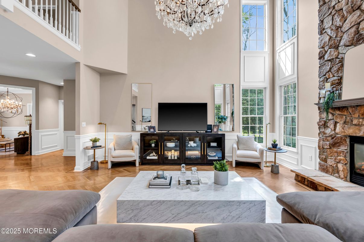 Chandelier, Fireplace, Interior, Living room, Recessed Lighting, Stone Walls, Wood Texture Flooring