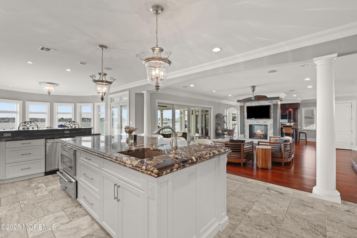 Chandelier, Dining room, Fireplace, Interior, Kitchen, Living room, Pendant Lights, Recessed Lighting, Stainless Steel Appliances, Wood Texture Flooring