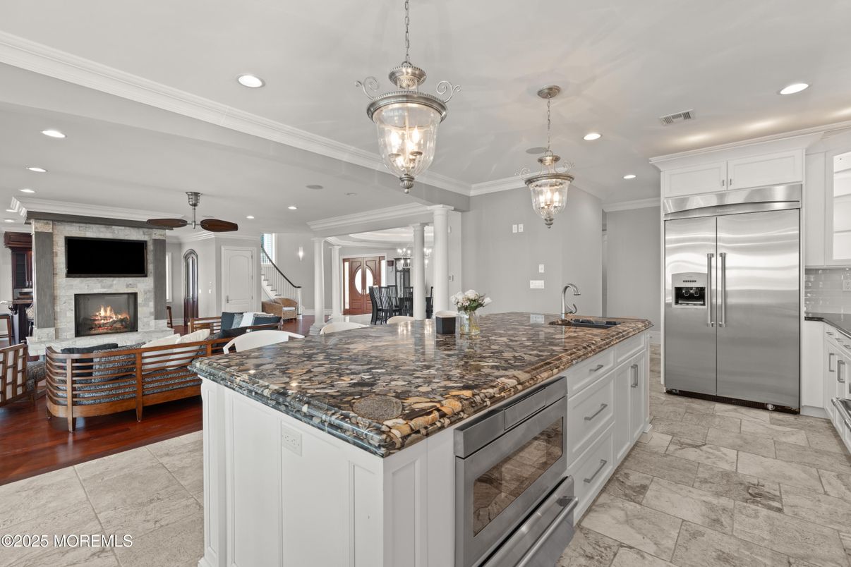 Chandelier, Dining room, Fireplace, Interior, Kitchen, Living room, Pendant Lights, Recessed Lighting, Stainless Steel Appliances