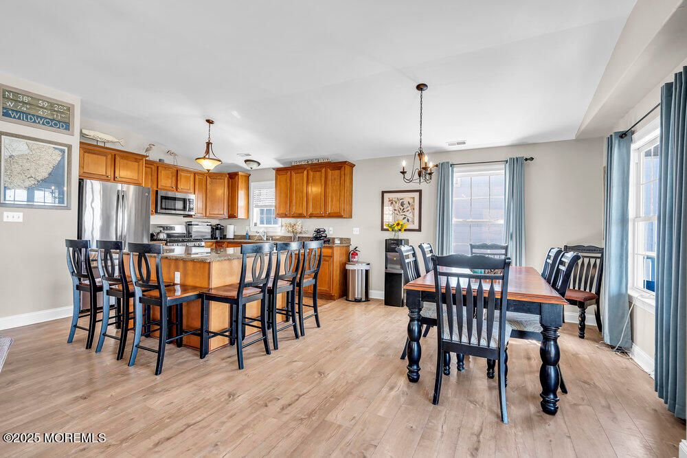 Chandelier, Dining room, Interior, Kitchen, Pendant Lights, Stainless Steel Appliances, Wood Texture Flooring