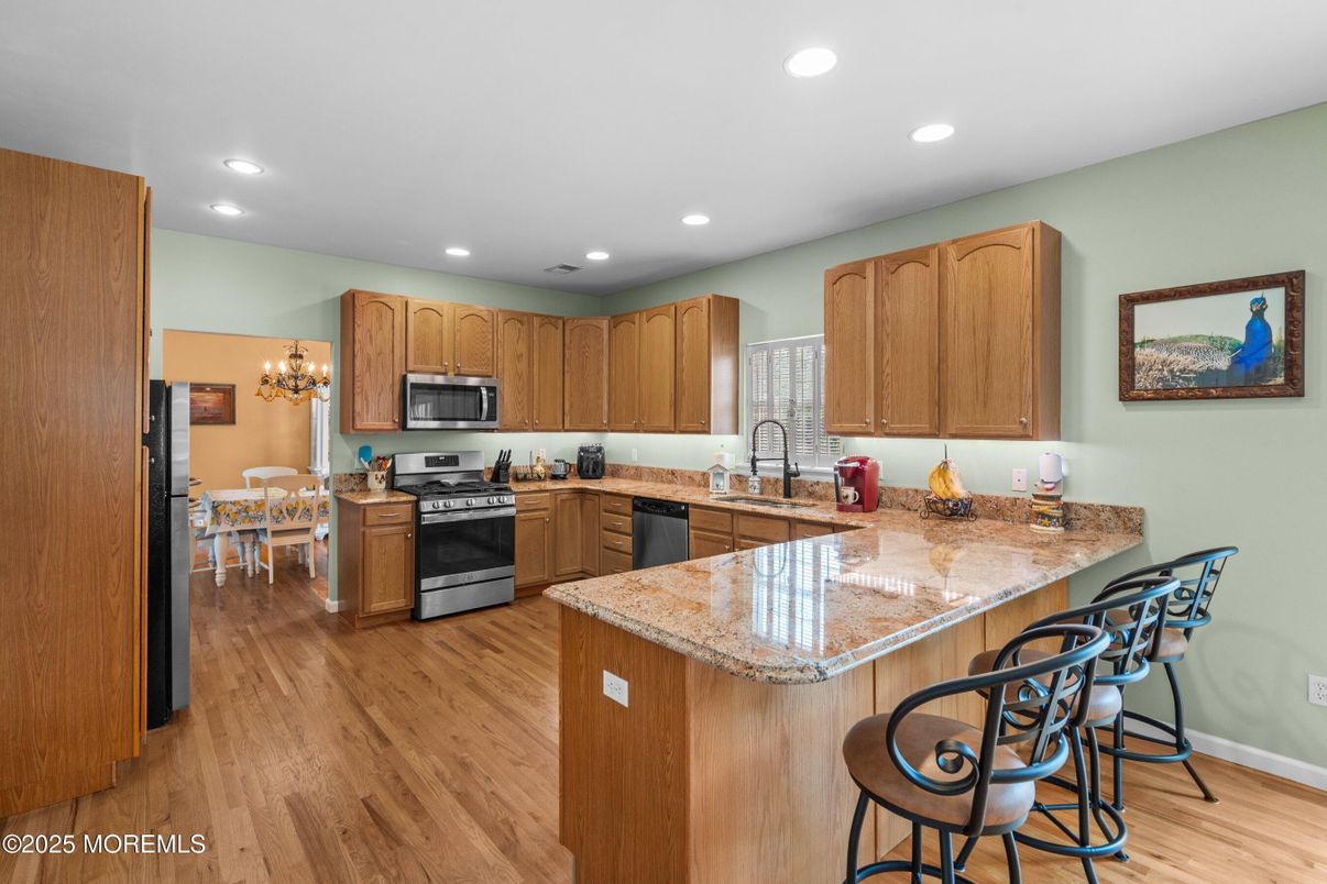 Chandelier, Dining room, Interior, Kitchen, Recessed Lighting, Stainless Steel Appliances, Wood Texture Flooring