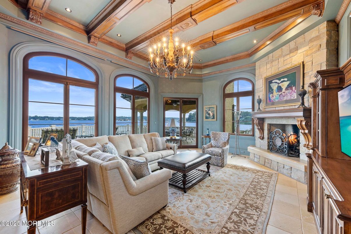 Chandelier, Fireplace, Interior, Living room, Recessed Lighting, Stone Walls, Water, Wooden Beams