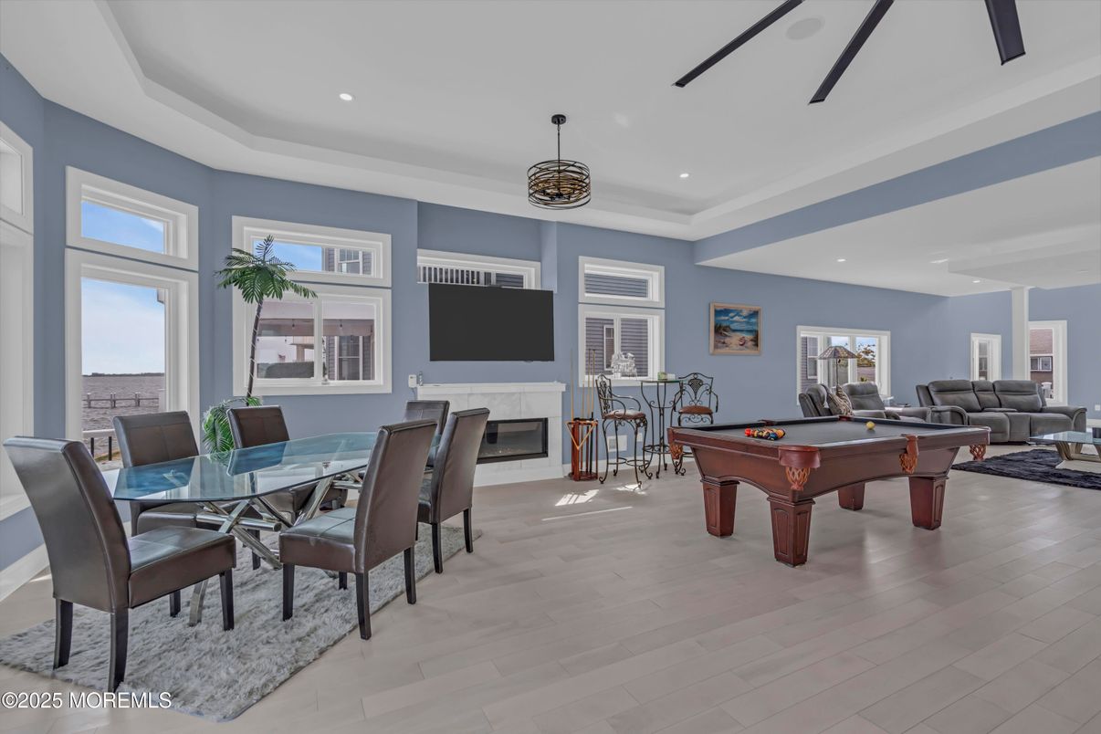 Billiard Table, Dining room, Fireplace, Game Room, Interior, Living room, Pendant Lights, Recessed Lighting, Wood Texture Flooring