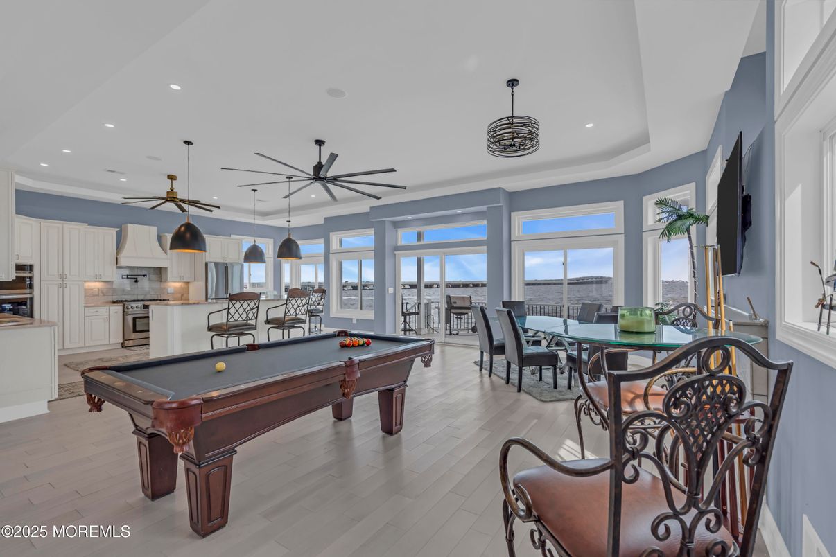 Billiard Table, Dining room, Game Room, Interior, Kitchen, Pendant Lights, Recessed Lighting, Stainless Steel Appliances, Wood Texture Flooring