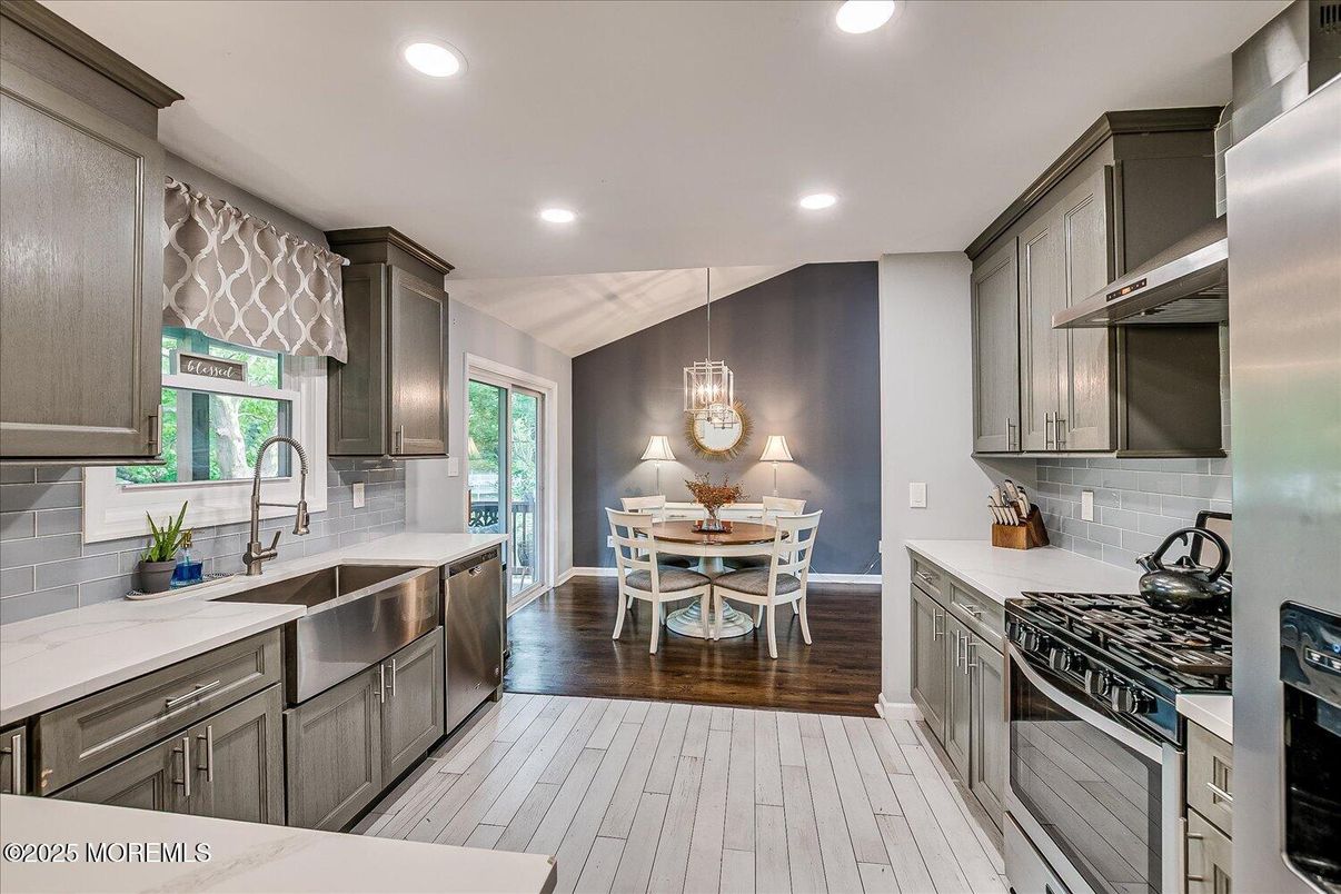 Chandelier, Dining room, Interior, Kitchen, Pendant Lights, Recessed Lighting, Stainless Steel Appliances, Wood Texture Flooring