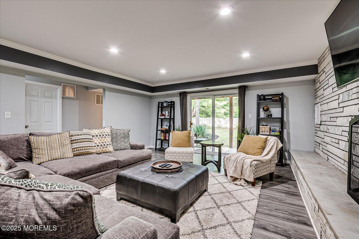 Fireplace, Interior, Living room, Recessed Lighting, Stone Walls, Wood Texture Flooring