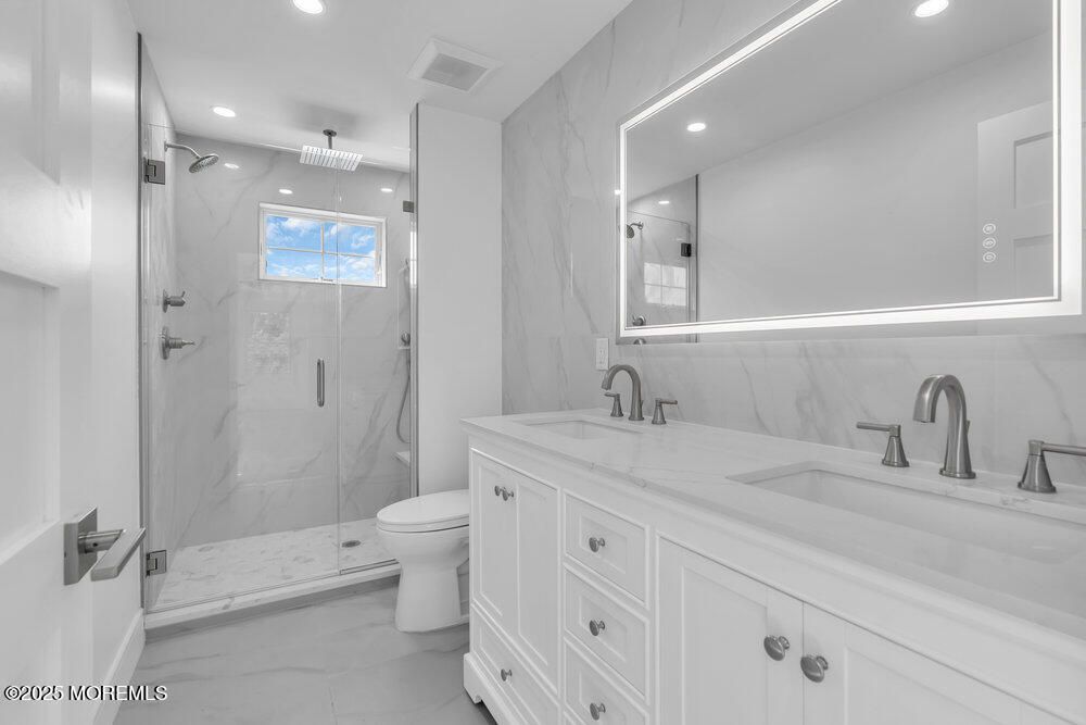 Bathroom, Dual Sink Vanities, Glass Shower, Interior, Marble, Marble Walls, Recessed Lighting