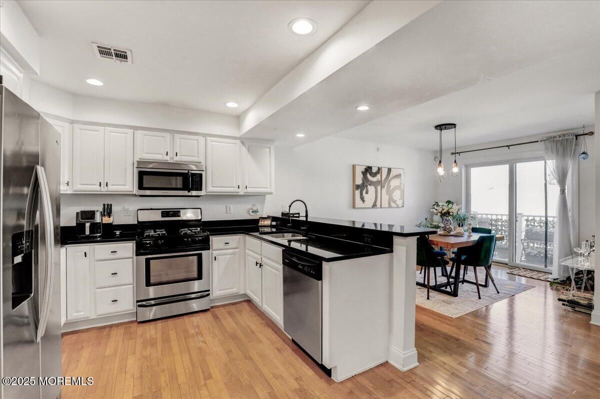 Dining room, Interior, Kitchen, Pendant Lights, Recessed Lighting, Stainless Steel Appliances, Wood Texture Flooring
