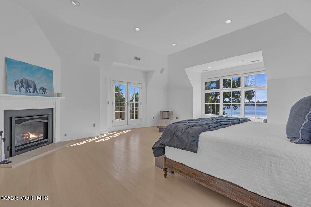 Bedroom, Fireplace, Interior, Recessed Lighting, Water, Wood Texture Flooring