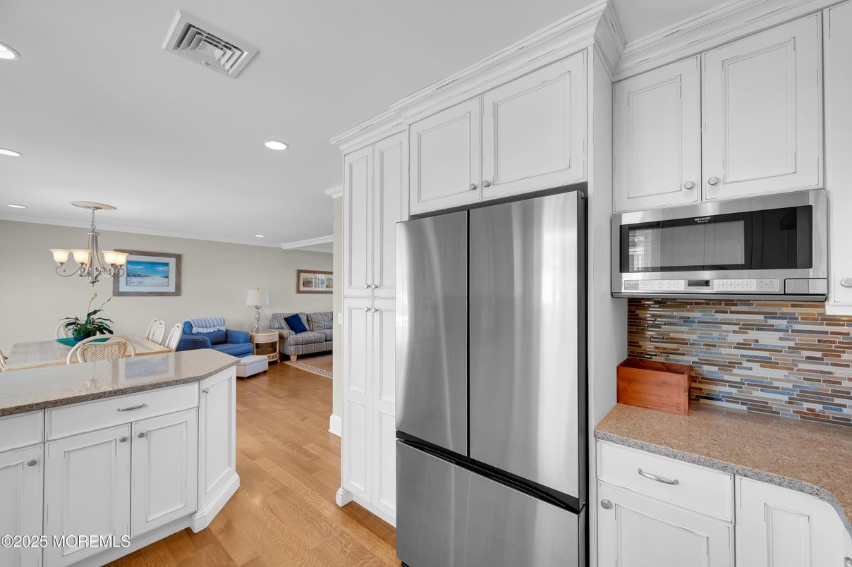Chandelier, Dining room, Interior, Kitchen, Living room, Recessed Lighting, Stainless Steel Appliances, Wood Texture Flooring