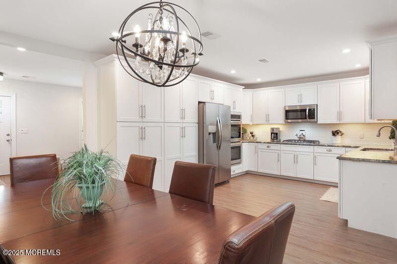 Chandelier, Dining room, Interior, Kitchen, Recessed Lighting, Stainless Steel Appliances, Wood Texture Flooring