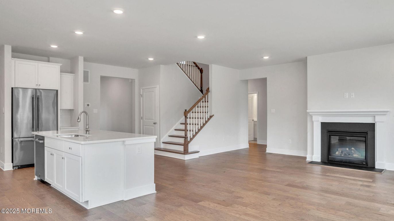 Fireplace, Interior, Kitchen, Recessed Lighting, Stainless Steel Appliances, Wood Texture Flooring