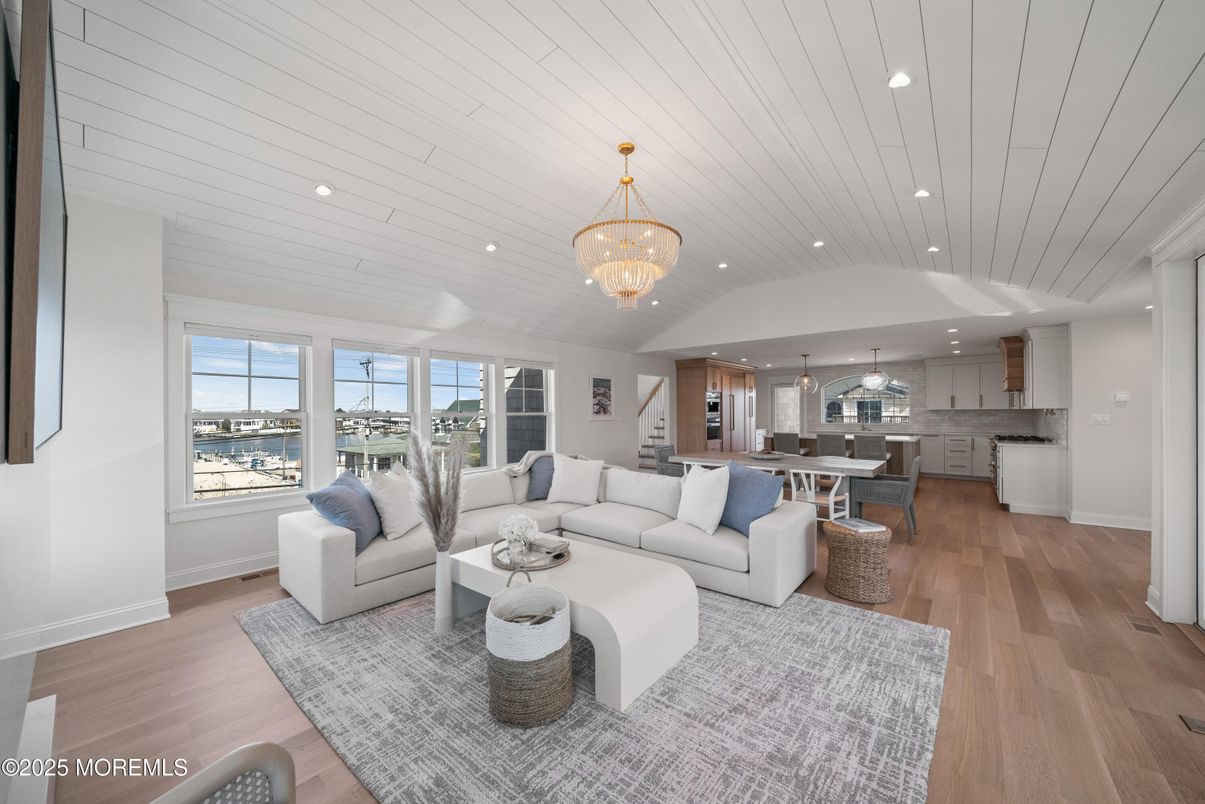 Chandelier, Dining room, Interior, Kitchen, Living room, Recessed Lighting, Water, Wood Texture Flooring