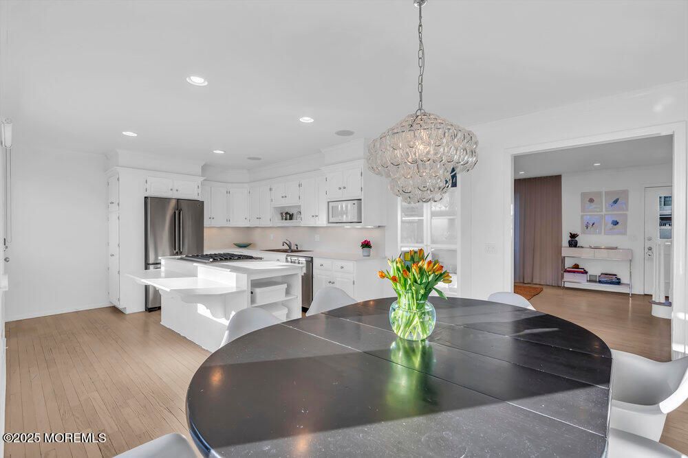 Chandelier, Dining room, Interior, Kitchen, Recessed Lighting, Stainless Steel Appliances, Wood Texture Flooring