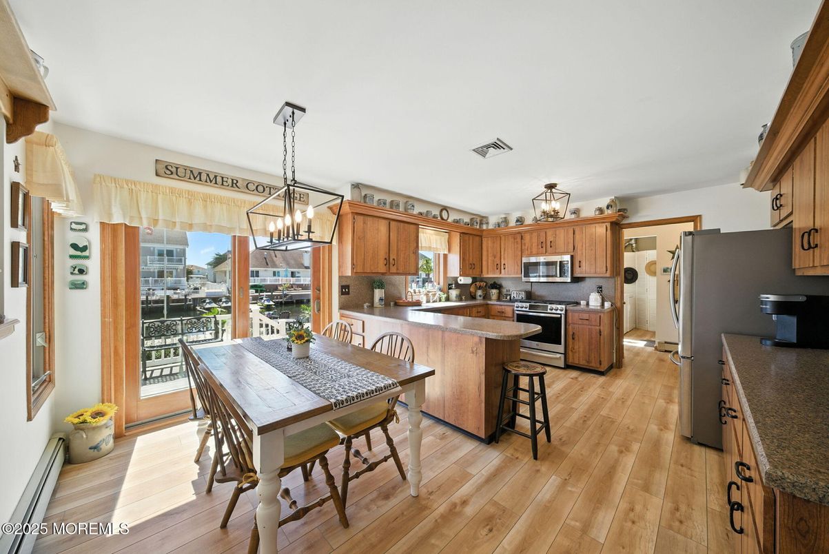 Chandelier, Dining room, Interior, Kitchen, Pendant Lights, Stainless Steel Appliances, Wood Texture Flooring