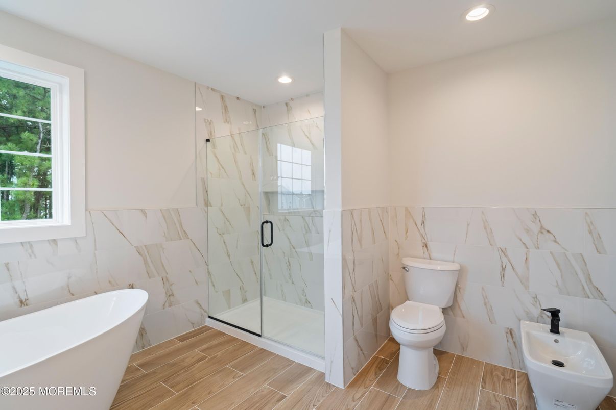 Bathroom, Free Standing Baths, Glass Shower, Interior, Marble Walls, Recessed Lighting, Wood Texture Flooring