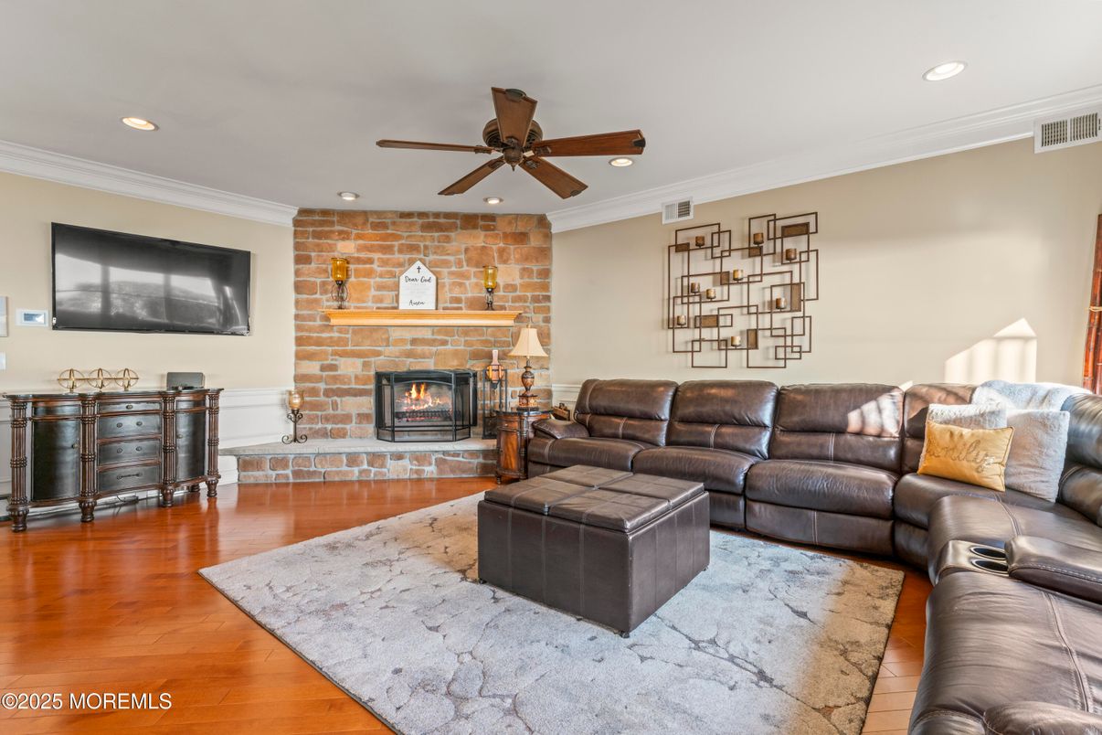 Fireplace, Interior, Living room, Recessed Lighting, Stone Walls, Wood Texture Flooring