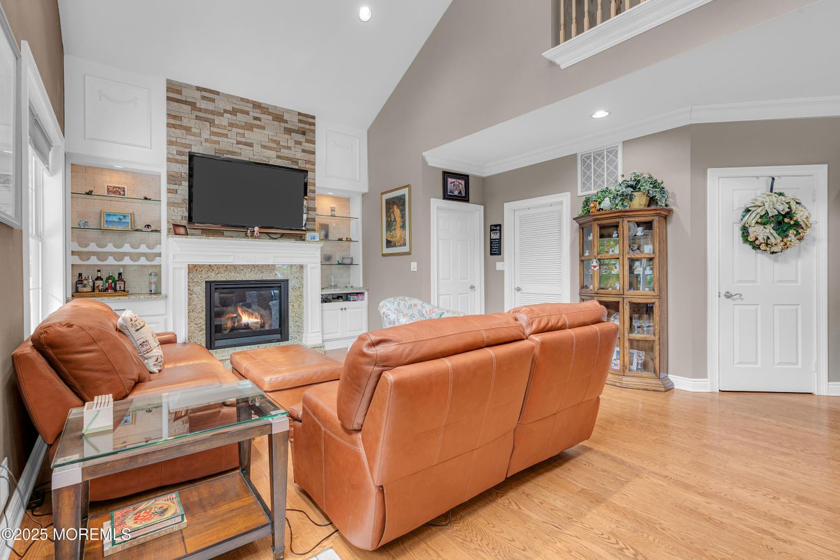 Fireplace, Interior, Living room, Recessed Lighting, Stone Walls, Wood Texture Flooring