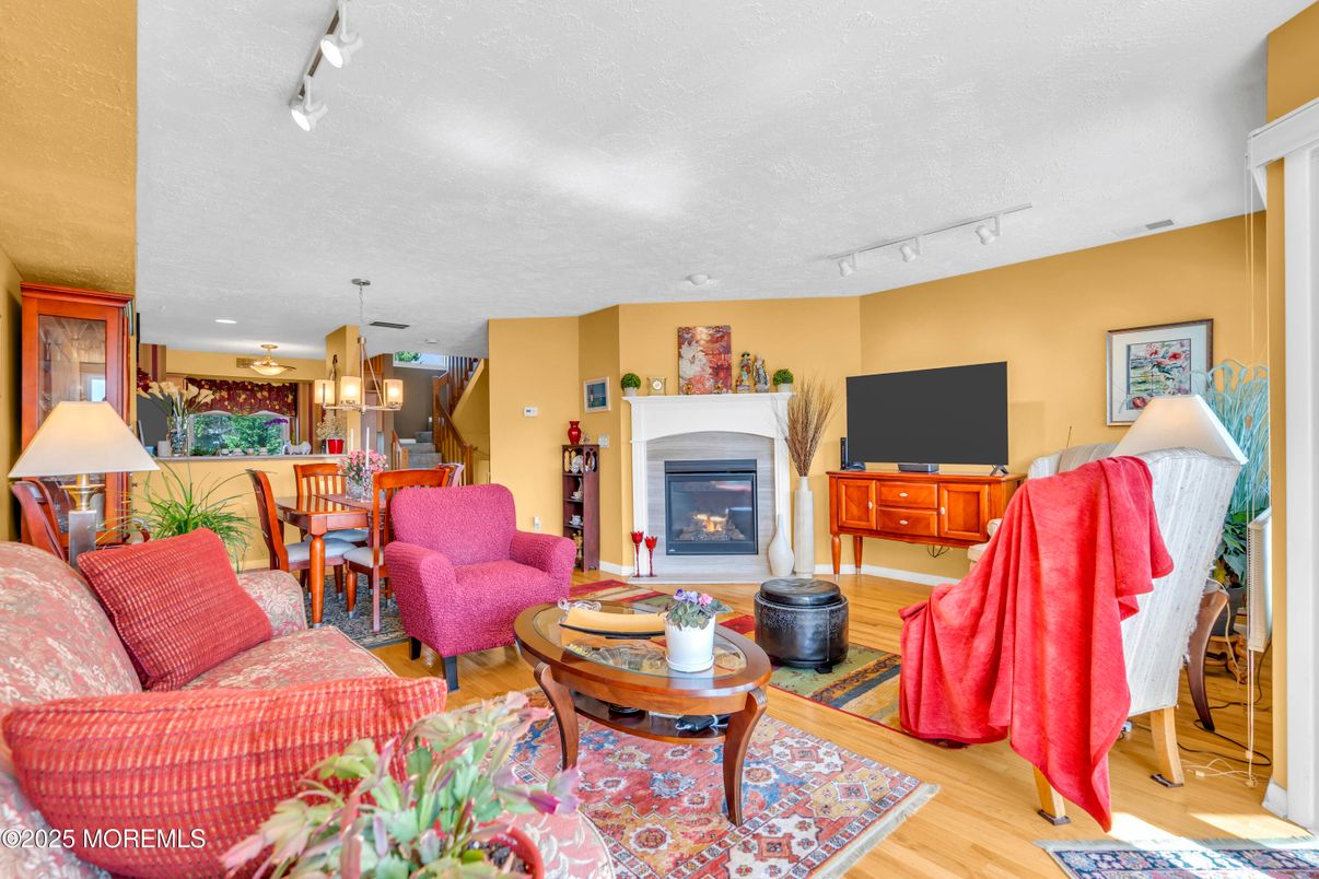 Dining room, Fireplace, Interior, Living room, Pendant Lights, Recessed Lighting, Wood Texture Flooring