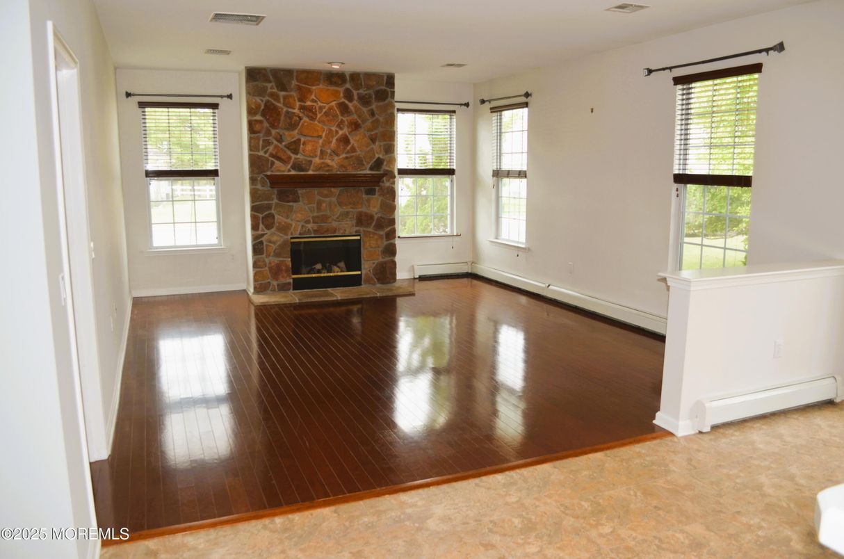 Empty room, Fireplace, Interior, Recessed Lighting, Stone Walls, Wood Texture Flooring