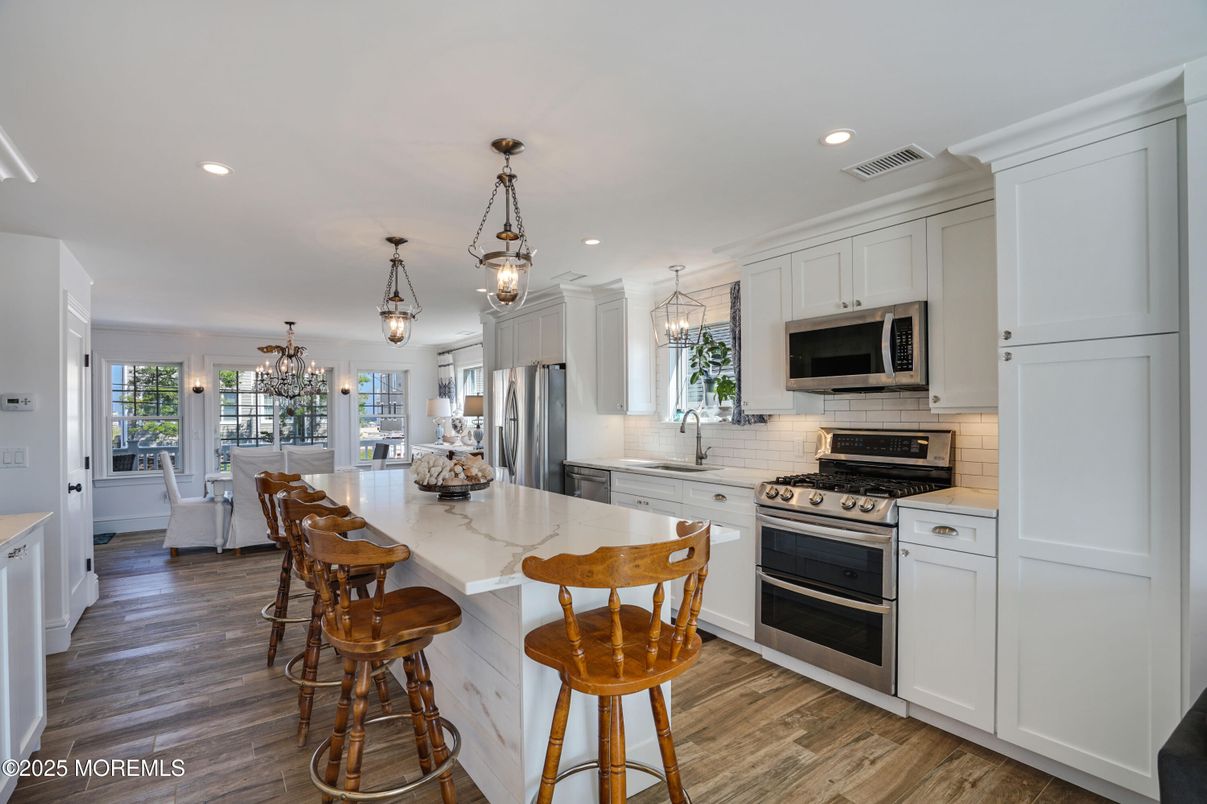 Chandelier, Dining room, Interior, Kitchen, Pendant Lights, Recessed Lighting, Stainless Steel Appliances, Wood Texture Flooring