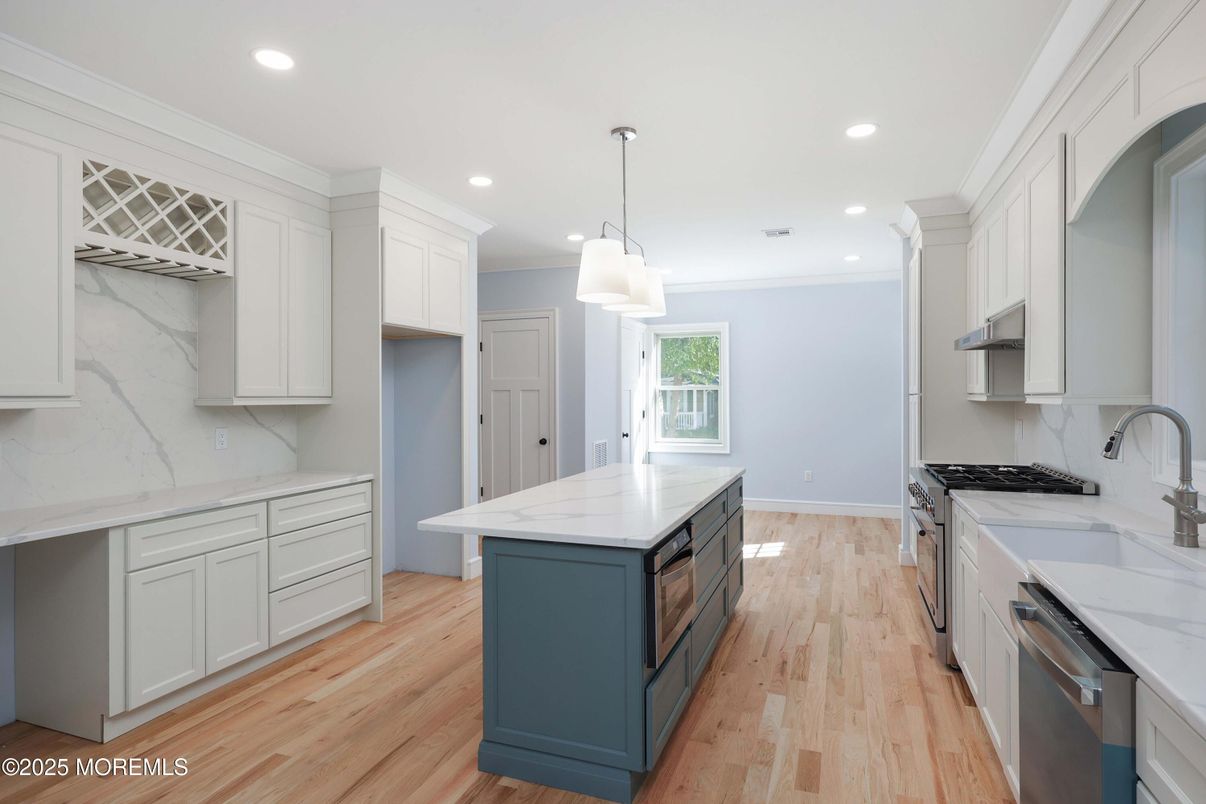 Interior, Kitchen, Marble Walls, Pendant Lights, Recessed Lighting, Stainless Steel Appliances, Wood Texture Flooring