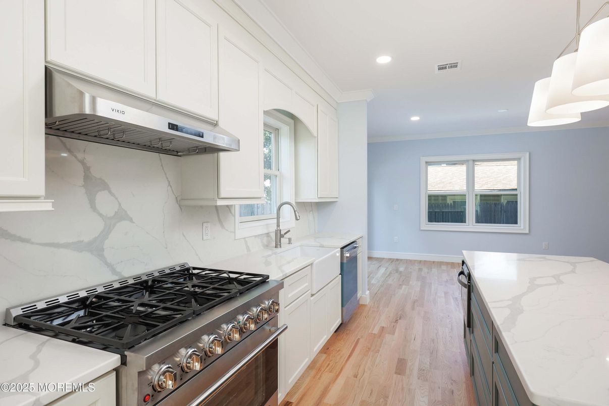 Interior, Kitchen, Marble Walls, Recessed Lighting, Stainless Steel Appliances, Wood Texture Flooring
