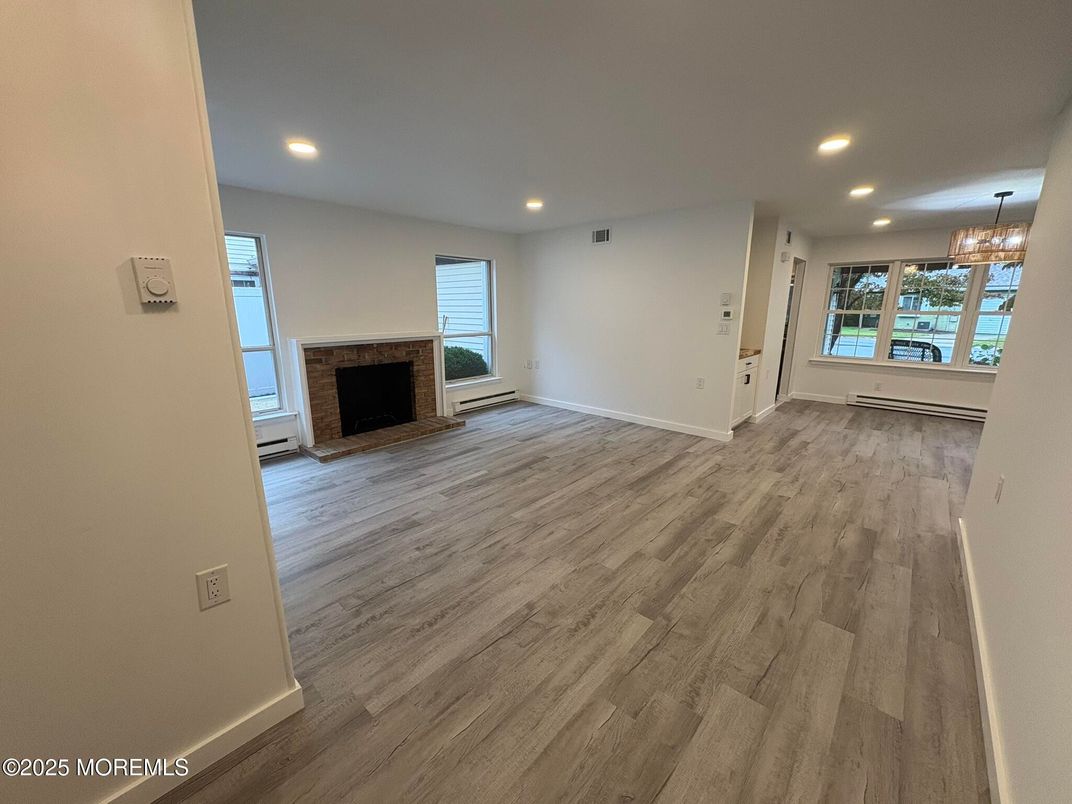 Chandelier, Empty room, Fireplace, Interior, Recessed Lighting, Wood Texture Flooring