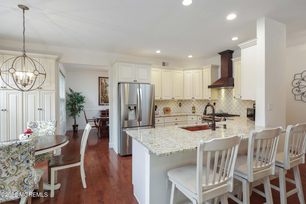 Dining room, Interior, Kitchen, Pendant Lights, Recessed Lighting, Stainless Steel Appliances, Wood Texture Flooring