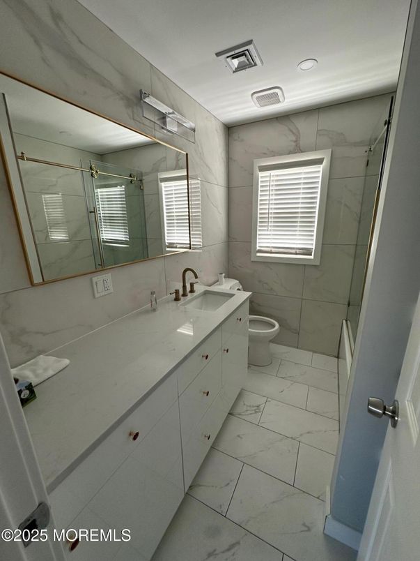 Bathroom, Dual Sink Vanities, Glass Shower, Interior, Marble, Marble Walls, Recessed Lighting