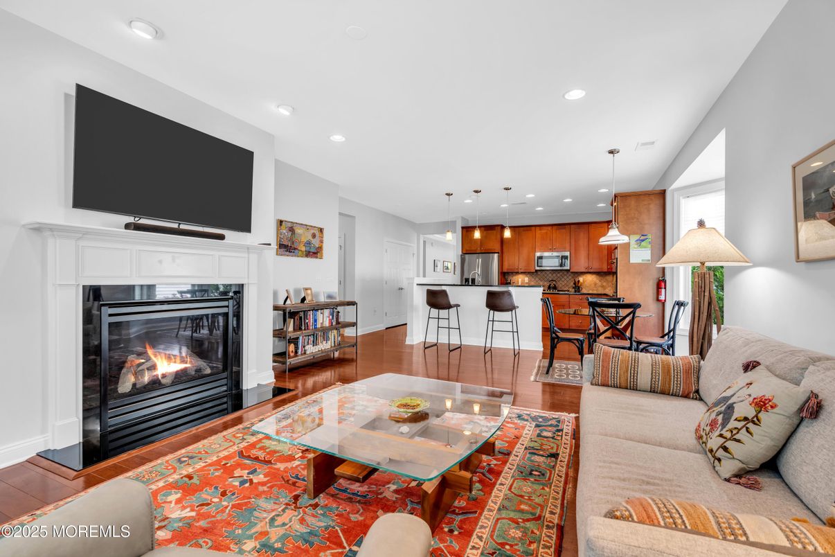 Dining room, Fireplace, Interior, Kitchen, Living room, Pendant Lights, Recessed Lighting, Stainless Steel Appliances, Wood Texture Flooring