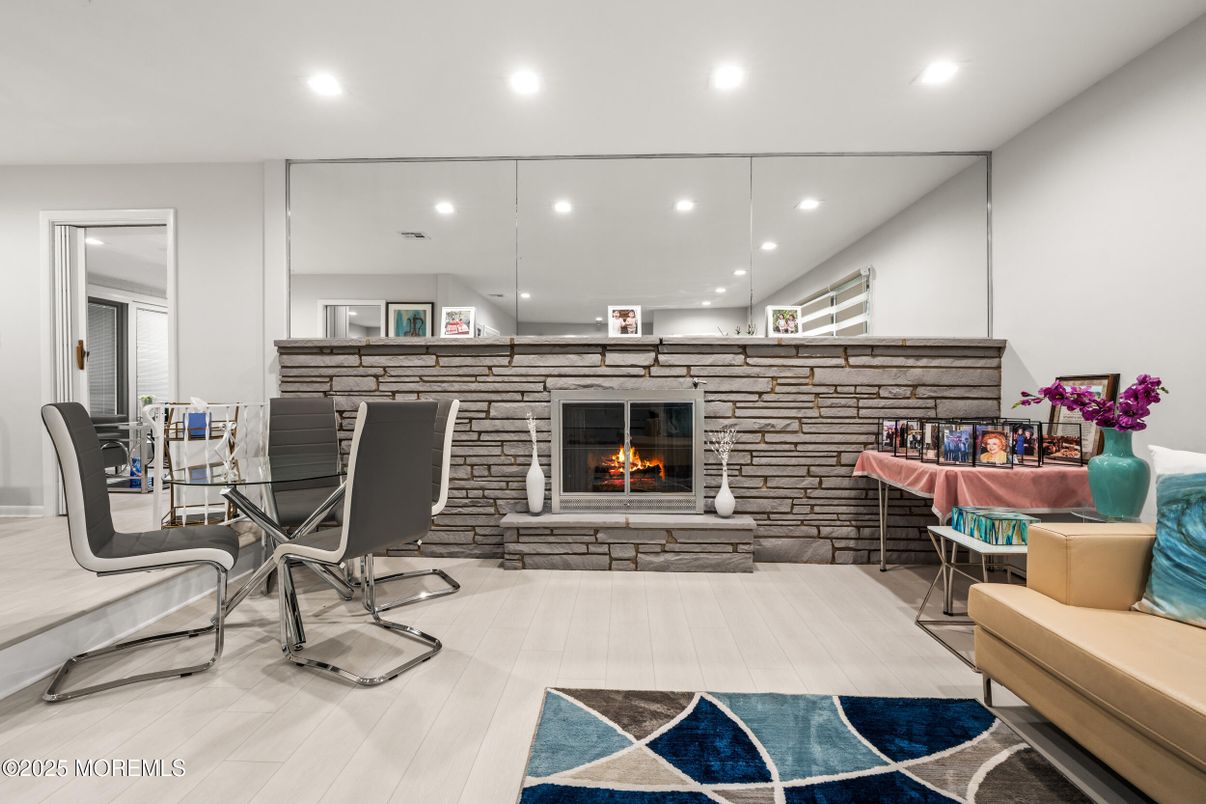 Dining room, Fireplace, Interior, Recessed Lighting, Stone Walls, Wood Texture Flooring