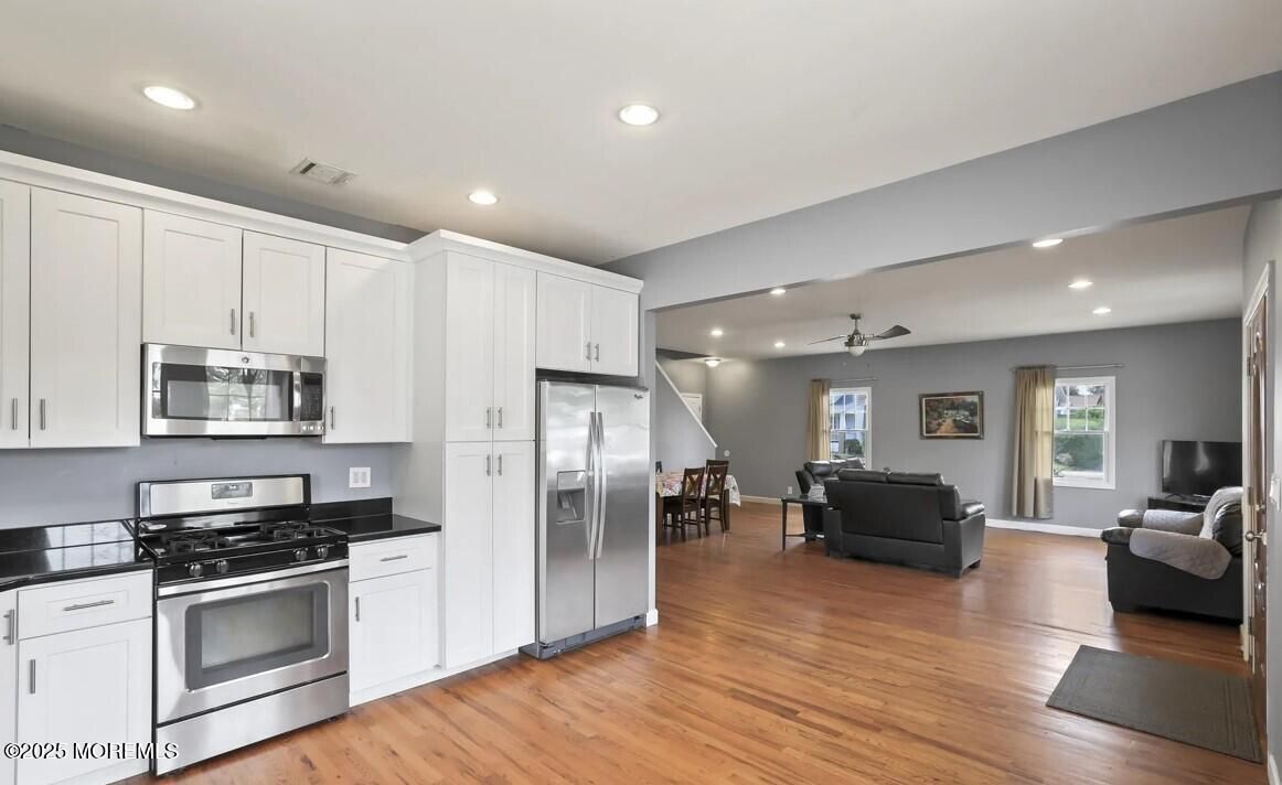Dining room, Interior, Kitchen, Living room, Recessed Lighting, Stainless Steel Appliances, Wood Texture Flooring