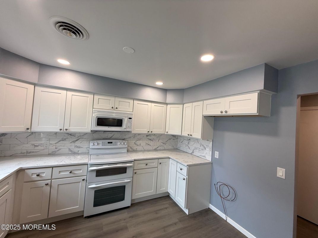 Interior, Kitchen, Marble Walls, Recessed Lighting, Stainless Steel Appliances, Wood Texture Flooring