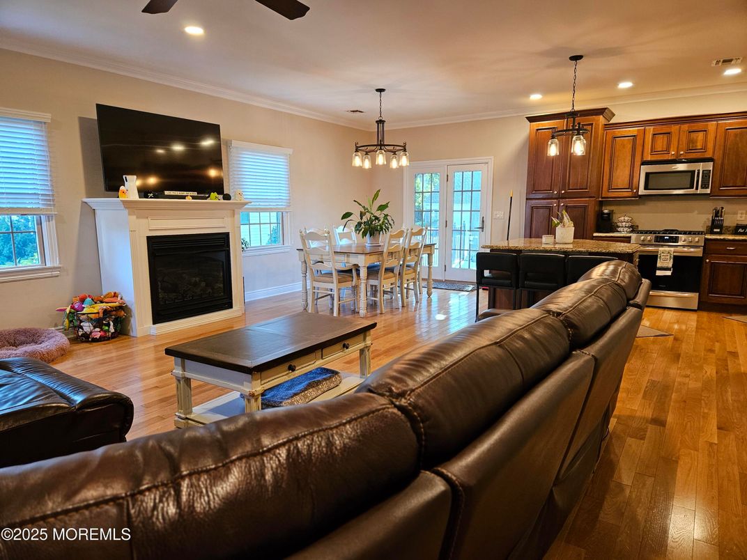 Dining room, Fireplace, Interior, Kitchen, Living room, Pendant Lights, Recessed Lighting, Stainless Steel Appliances, Wood Texture Flooring