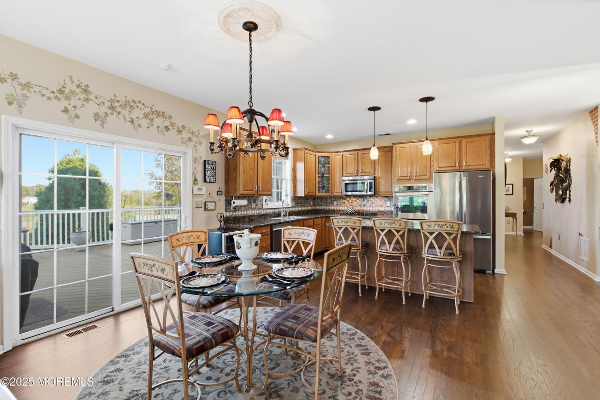 Chandelier, Dining room, Interior, Kitchen, Pendant Lights, Recessed Lighting, Stainless Steel Appliances, Wood Texture Flooring