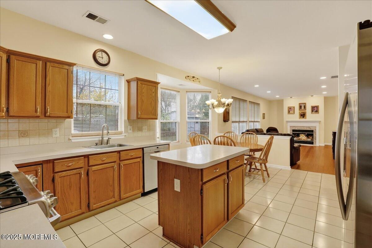 Chandelier, Dining room, Fireplace, Interior, Kitchen, Living room, Recessed Lighting, Stainless Steel Appliances