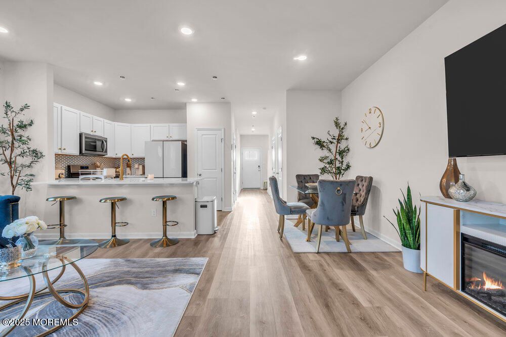Dining room, Fireplace, Interior, Kitchen, Recessed Lighting, Stainless Steel Appliances, Wood Texture Flooring