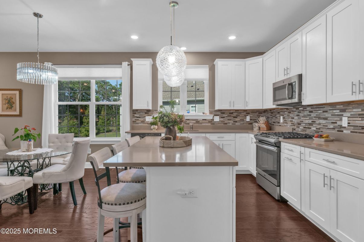Chandelier, Dining room, Interior, Kitchen, Pendant Lights, Recessed Lighting, Stainless Steel Appliances, Wood Texture Flooring