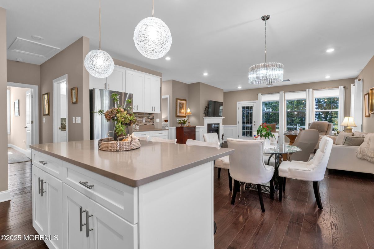 Chandelier, Dining room, Interior, Kitchen, Living room, Pendant Lights, Recessed Lighting, Stainless Steel Appliances, Wood Texture Flooring