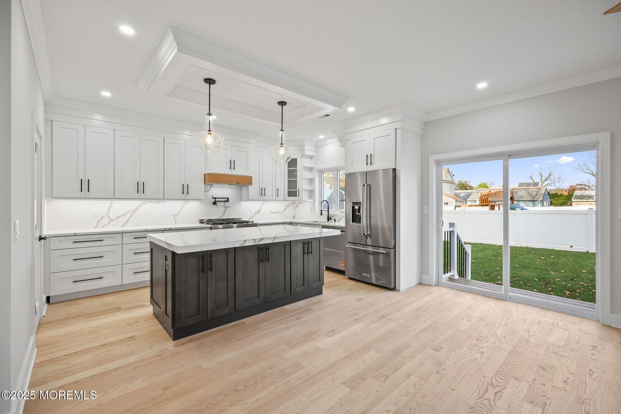 Interior, Kitchen, Marble Walls, Pendant Lights, Recessed Lighting, Stainless Steel Appliances, Wood Texture Flooring