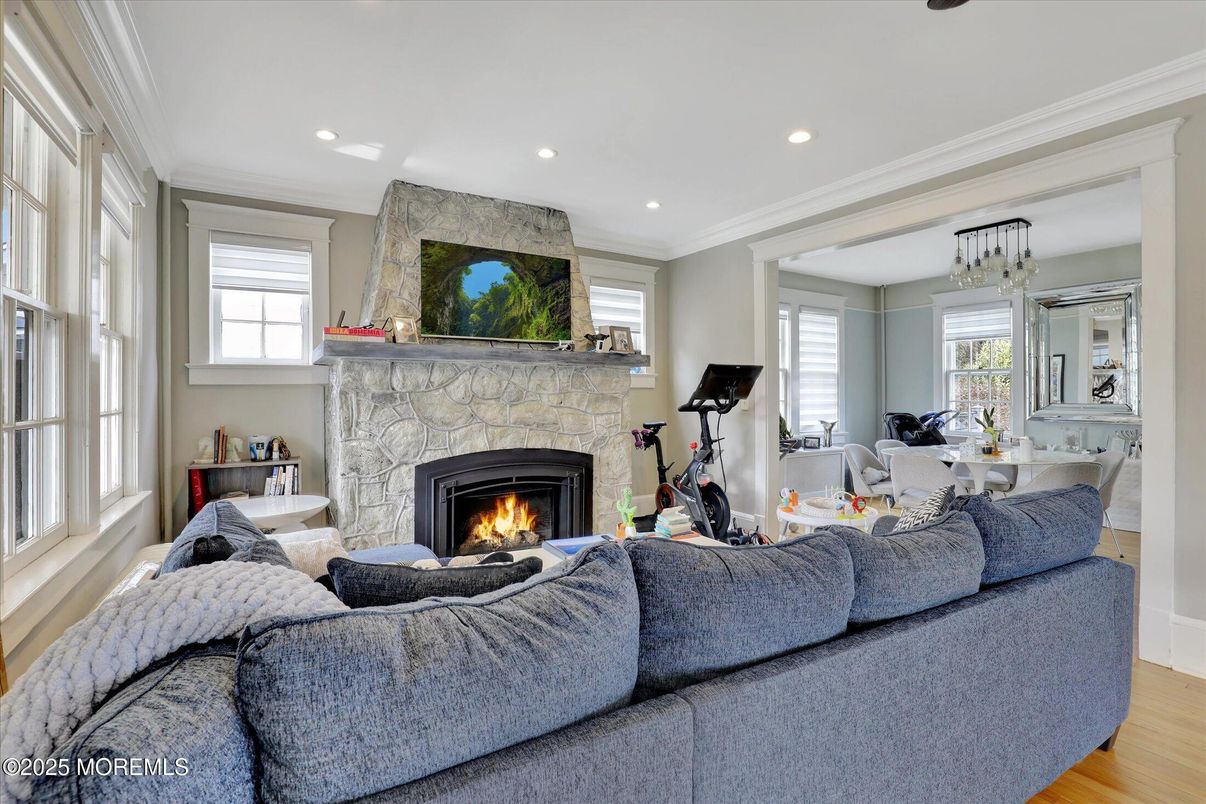 Chandelier, Fireplace, Fitness Equipment, Interior, Living room, Recessed Lighting, Stone Walls, Wood Texture Flooring
