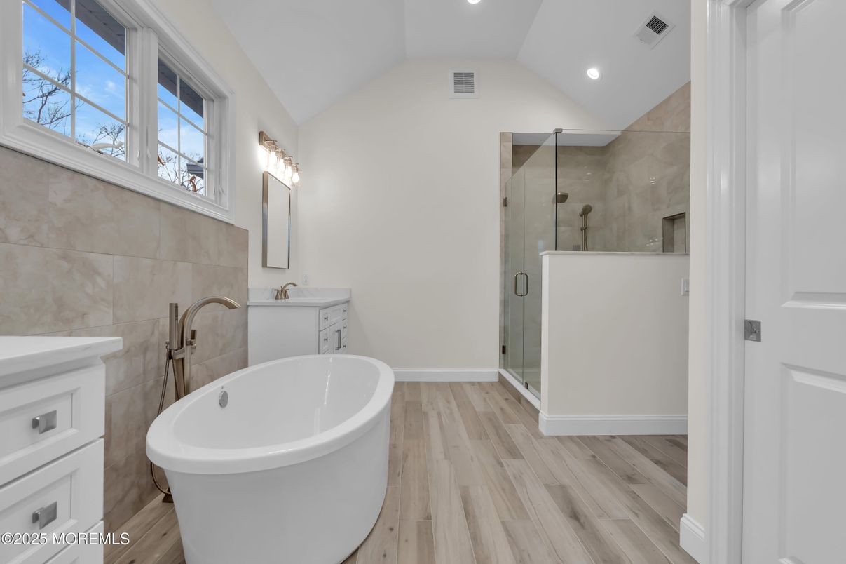 Bathroom, Free Standing Baths, Glass Shower, Interior, Recessed Lighting, Wood Texture Flooring
