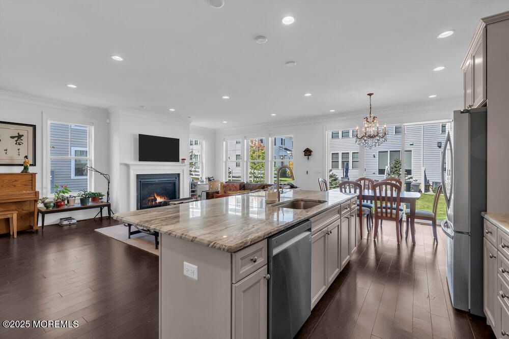 Chandelier, Dining room, Fireplace, Interior, Kitchen, Living room, Recessed Lighting, Wood Texture Flooring