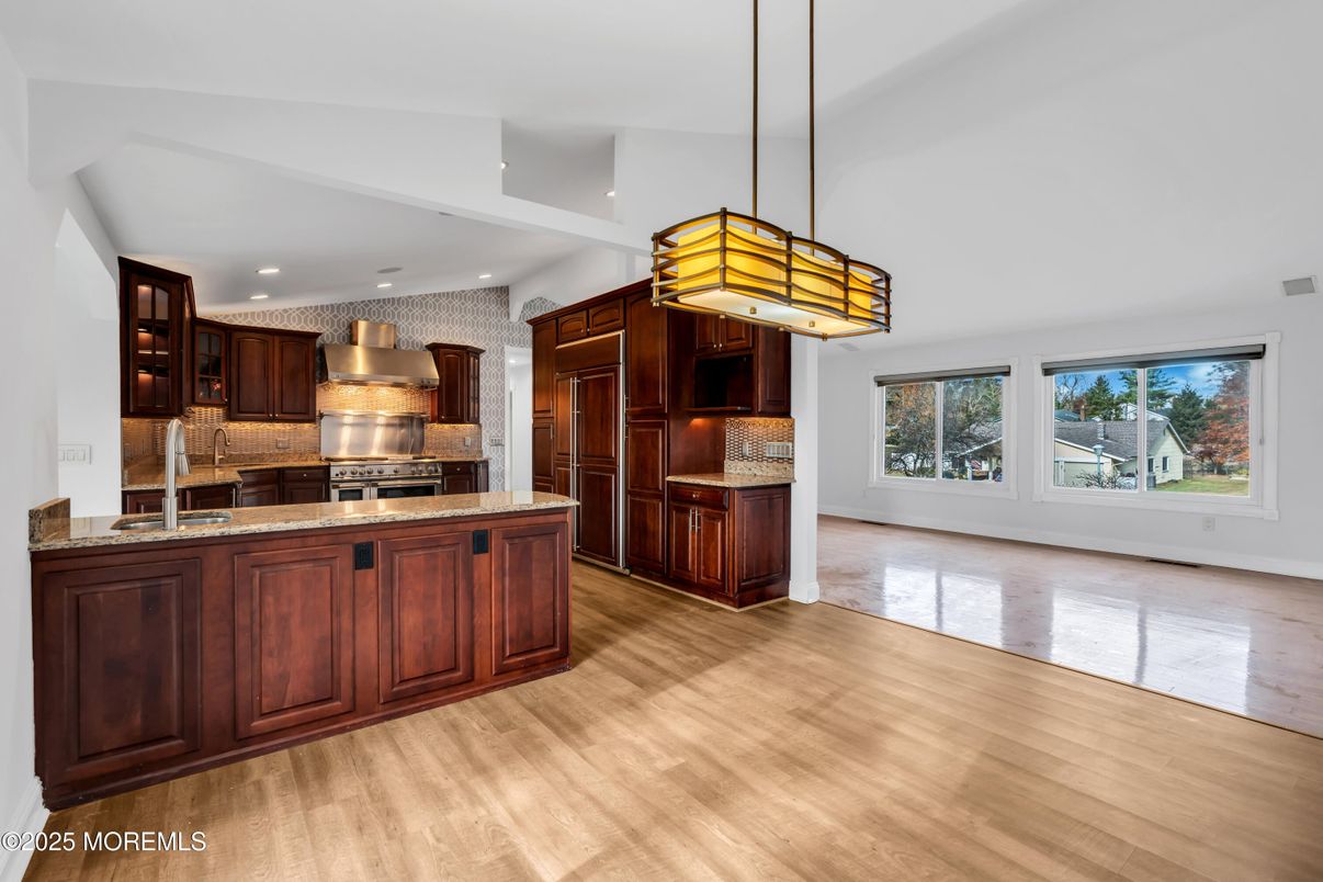 Empty room, Interior, Kitchen, Pendant Lights, Recessed Lighting, Stainless Steel Appliances, Wood Texture Flooring