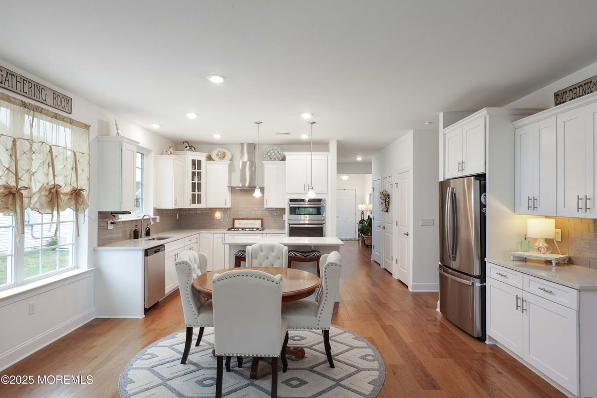 Dining room, Interior, Kitchen, Pendant Lights, Recessed Lighting, Stainless Steel Appliances, Wood Texture Flooring