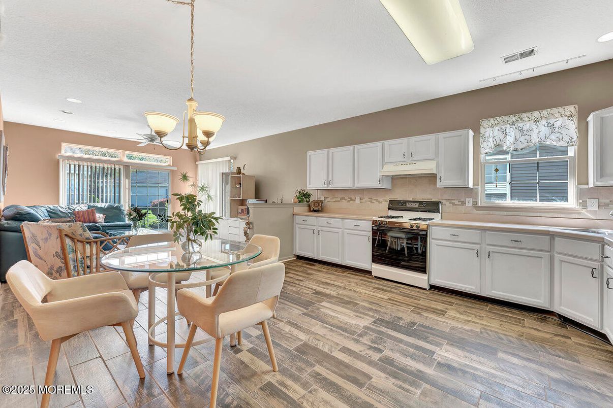 Dining room, Interior, Kitchen, Pendant Lights, Recessed Lighting, Stainless Steel Appliances, Wood Texture Flooring